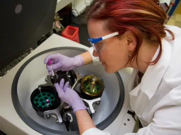 Technician with centrifuge